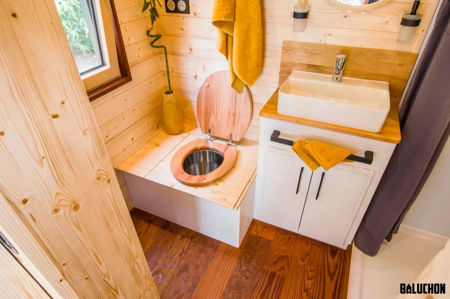 The Piccola Casa's bathroom includes a shower, sink, toilet and some storage space