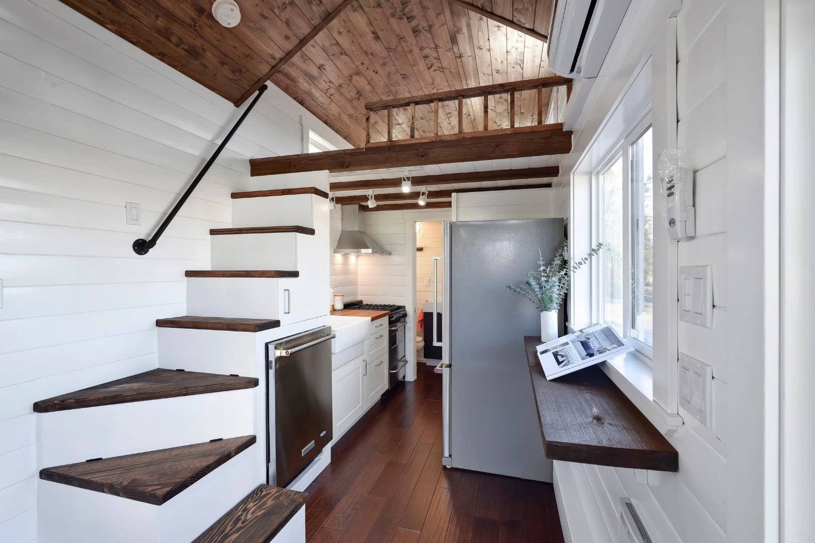 The master bedroom loft is accessible via a bespoke staircase that runs parallel to the kitchen