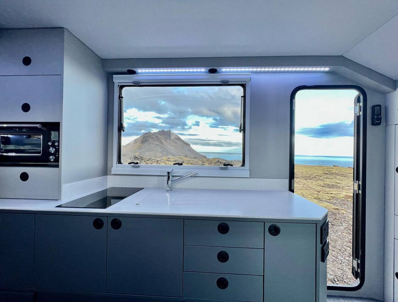 The EXP-8 galley comes standard with a dual-burner induction cooktop, stainless steel sink, filtered water tap, 10-wine bottle holder, 188-L fridge/freezer and large hatch for