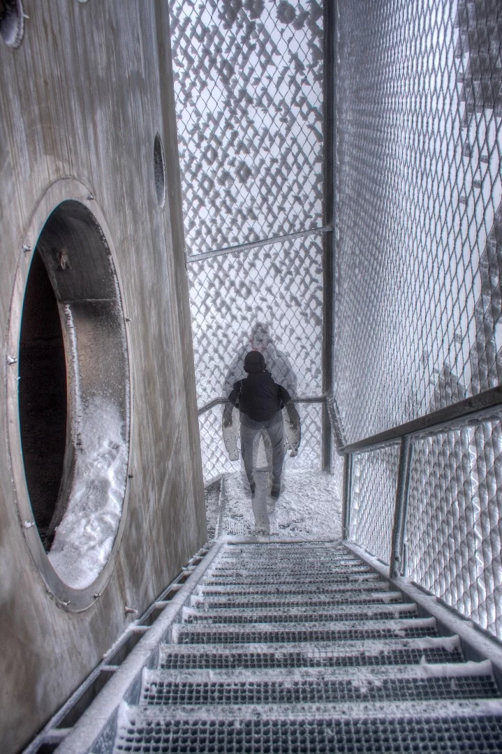 Visitors reach the shelters via an encircling steel staircase that's encased by steel mesh