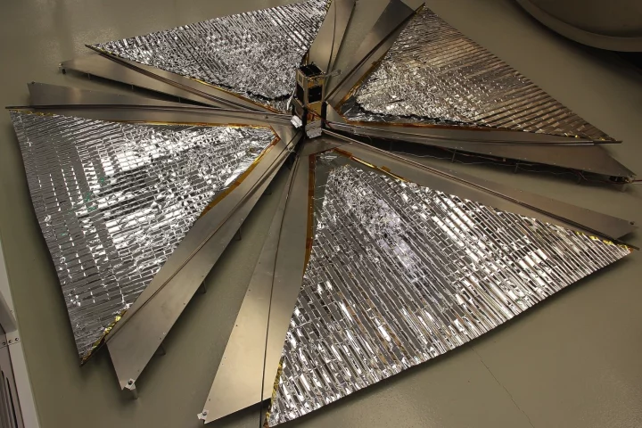 The CanX-7 satellite with its 1 square-meter (10.78 sq ft) drag sails unfurled, in a test before launch