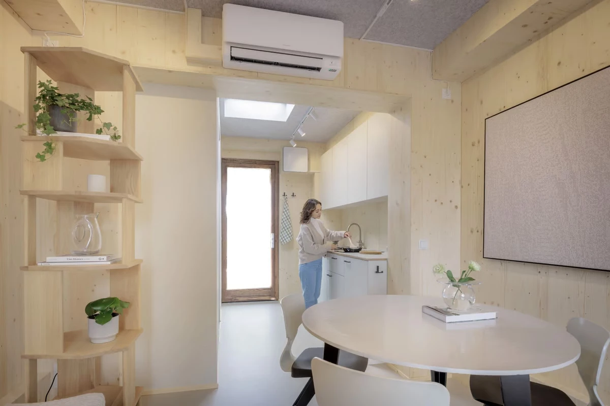The Nestle features a wooden interior with a kitchenette, bathroom, and sleeping and living areas