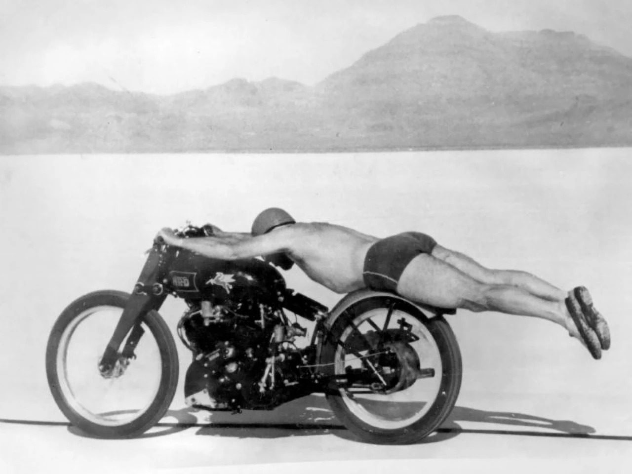Possibly the most memorable single image of a motorcycle is the above photograph of Roland "Rollie" Free breaking the American motorcycle land speed record on September 13, 1948 at Bonneville. Unable to beat the record in his leather racing suit, he had the idea of doing it "au naturel" to reduce wind resistance, subsequently registering a run of 150.313 mph (241.905 km/h) on his Vincent HRD 1000cc V-twin with the famous image recorded during that run. Given that Bonneville came to prominence as a venue for land speed record attempts because it is a vast salt flat, a blown tire or one of those unstoppable tank-slappers that every motorcyclist dreads, would almost certainly have seen Rollie sandpapered into the scenery. The image captures so much of the mix of freedom and imminent danger that is at the very core of motorcycle competition.The Vincent in this image was found and restored by attorney-restorer-historian-curator-of beautiful-objects Herb Harris and reluctantly sold when he was made an offer he couldn't refuse. The bike reportedly changed hands privately for $1.1 million.