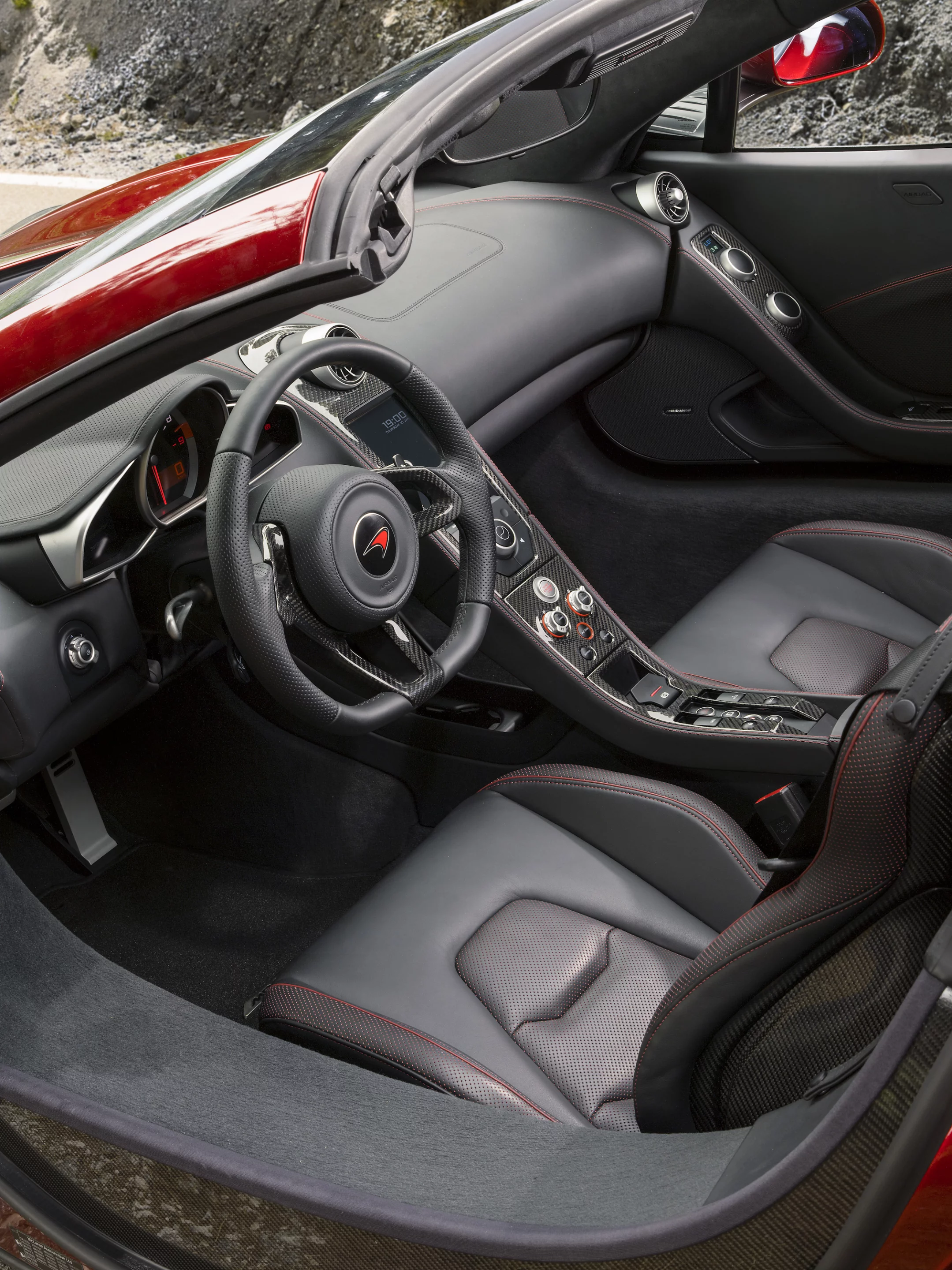 The 12C Spider’s RHT is operated via a switch in the lower section of the center console