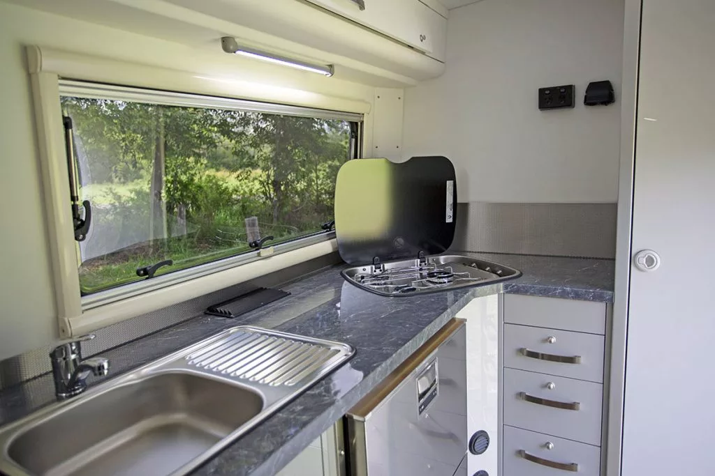 The corner position of the stove helps maximize usable counter space and provide two-person kitchen access