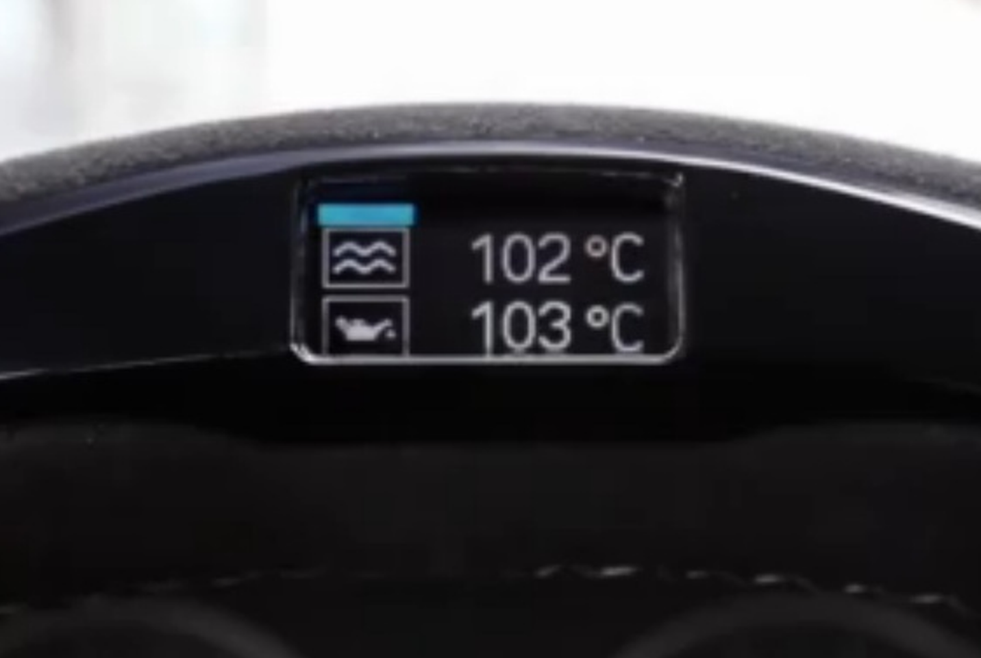 The BMW M Performance steering wheel showing engine and oil temperature