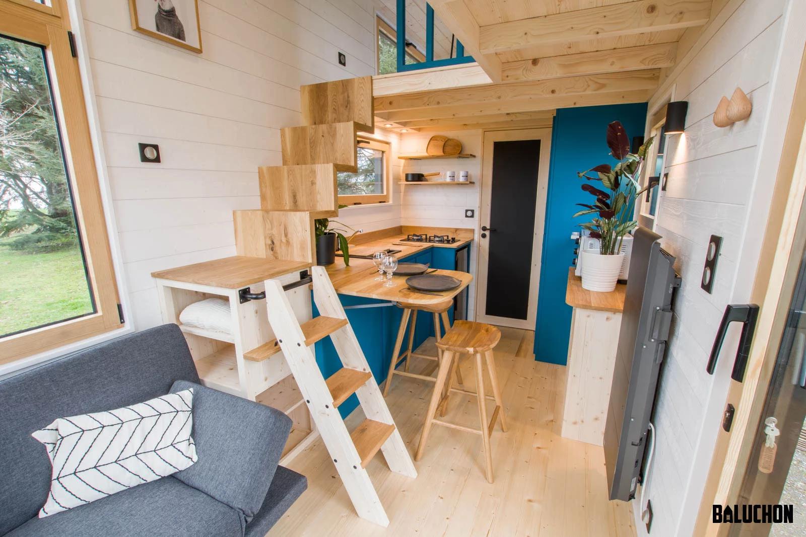 The Kejadenn's staircase is built into the kitchen cabinetry to save floorspace