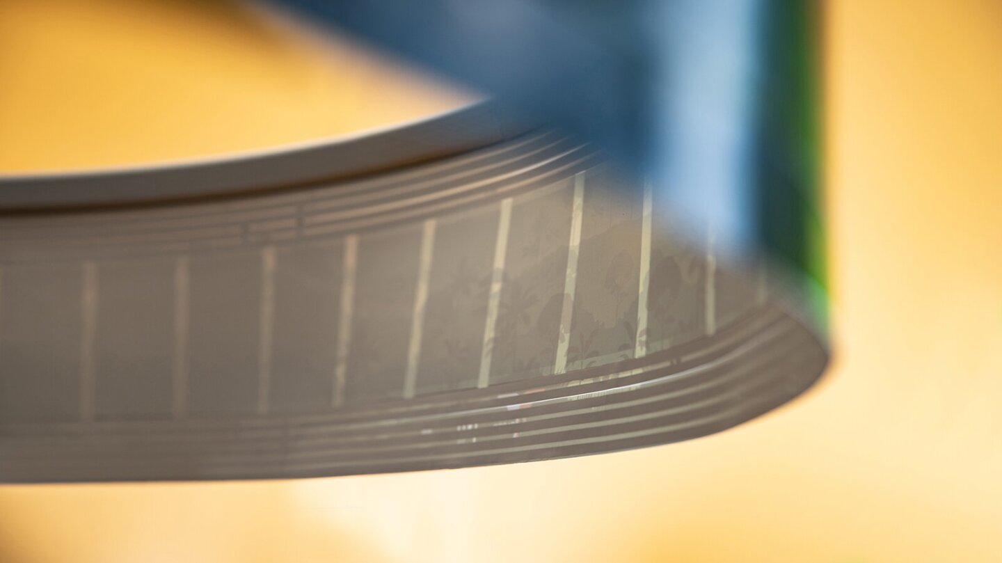 The printed speakers are embedded almost invisibly in the paper web but can be seen with strong backlighting
