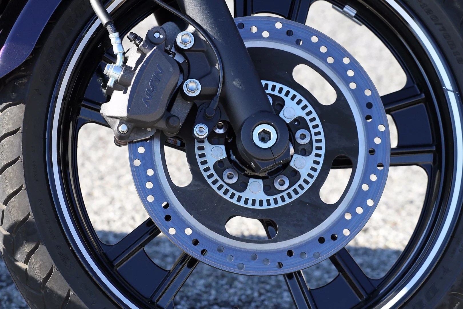 The front two-piston Nissin brake caliper (ABS version) of the Kawasaki Vulcan S