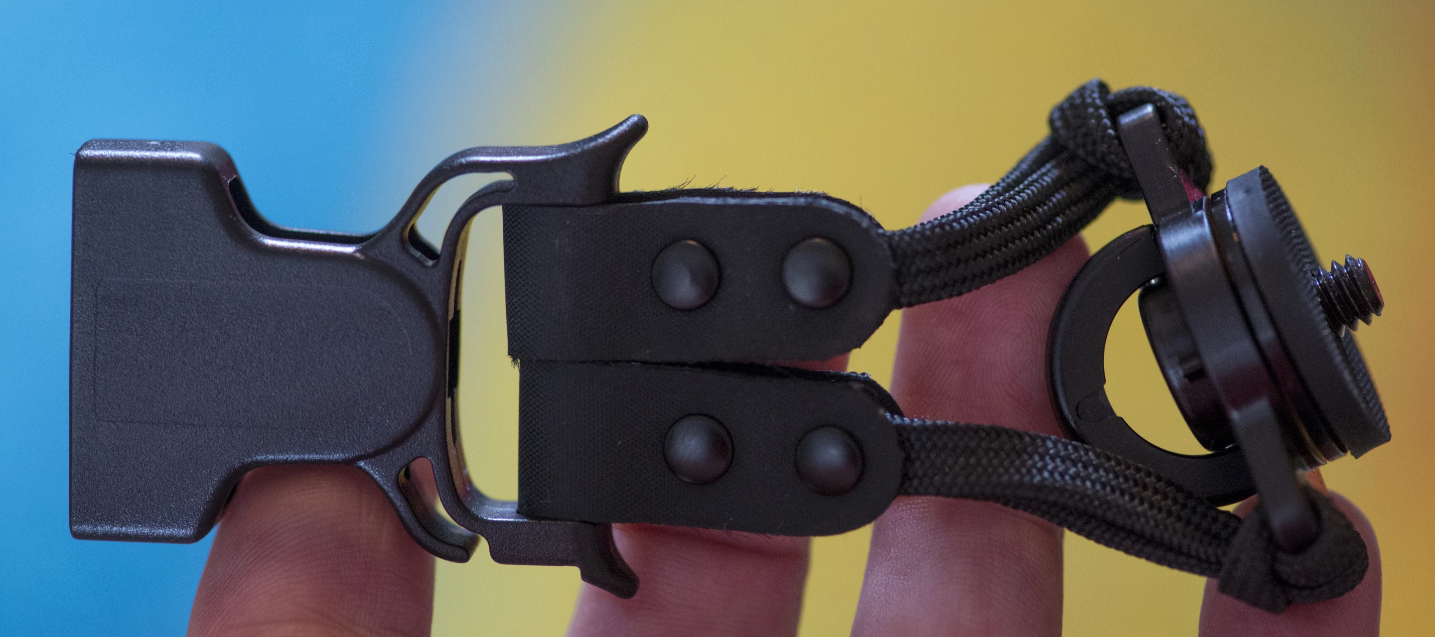 Cameras attach to the Custom SLR Dual Camera Strap using a strap with a C-Loop Mount which screws into the tripod socket of a camera at one end, and a quick attach buckle at the other