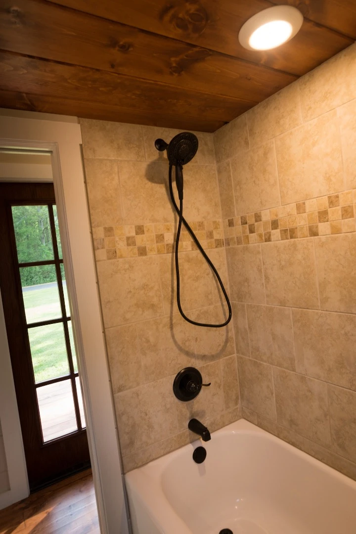 The Retreat's bathroom features a full-size bath with shower over