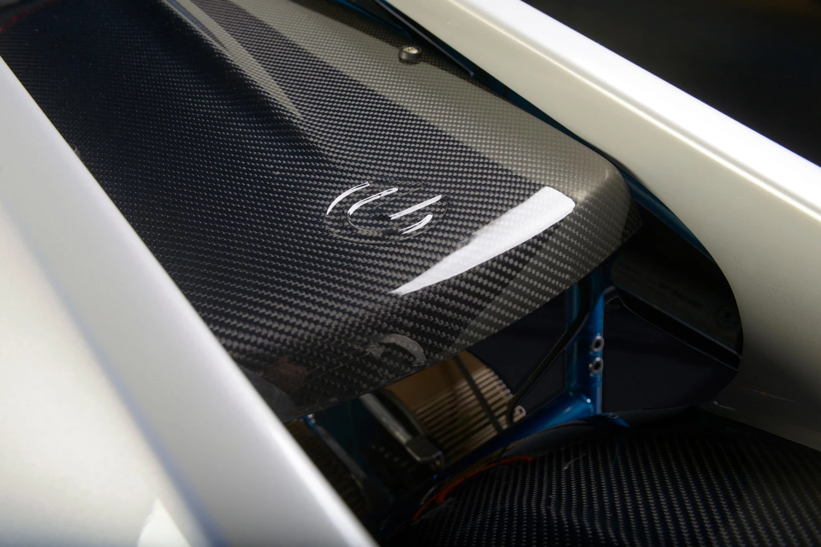 One of the T-Rex electric's motors peeking out from below some tasty carbon fiber bodywork