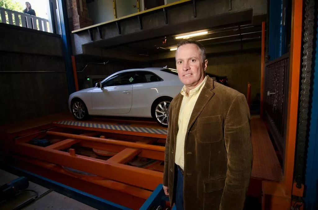 AutoParkit president Christopher Alan next to the lift in the lower level of the Sherman Oaks facility