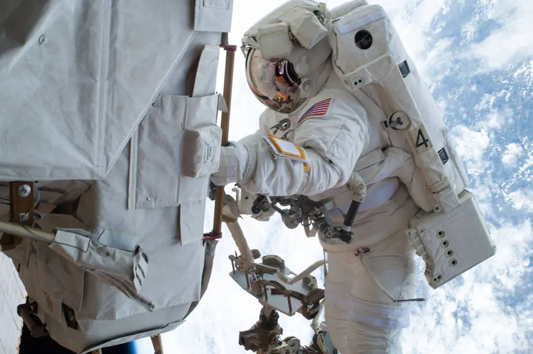 A spacewalking astronaut on a mission to change a faulty water pump on the International Space Station