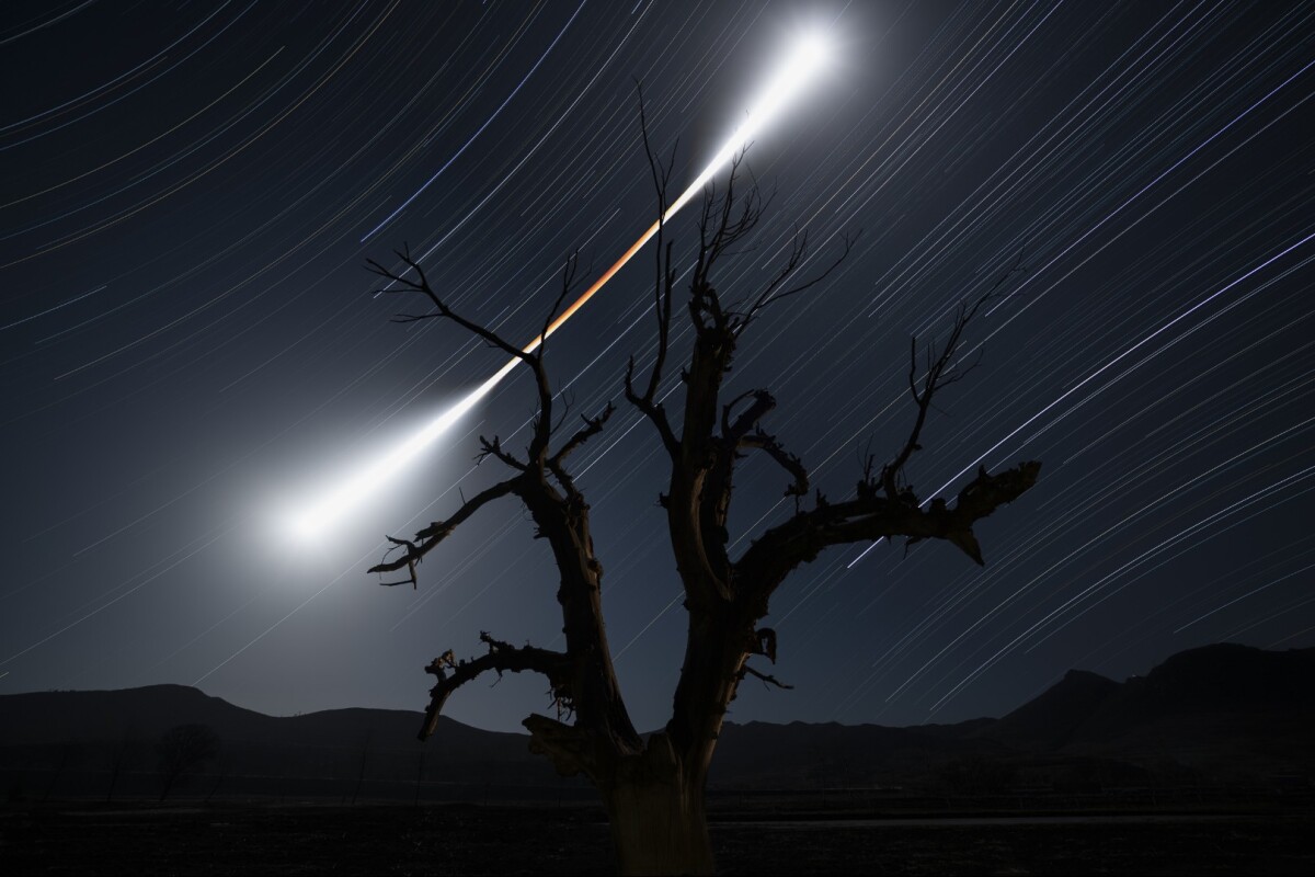 Runner-Up in Skyscapes. On 31 January 2018, a spectacular total lunar eclipse occurred. The photographer set his camera for a four-hour stack exposure and after he took about one thousand images, he finally captured an image that reflects the changes of the Moon's colour and brightness before, during and after the eclipse