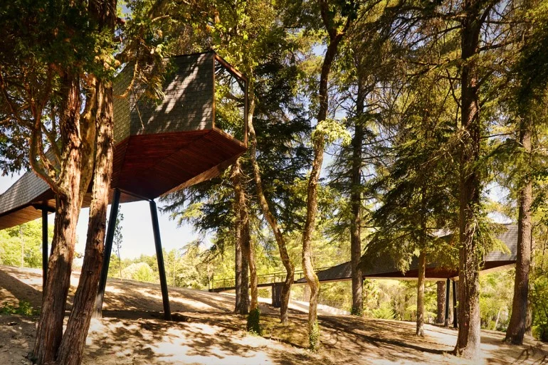 The Tree Snake Houses, by RA Architectural and Design Studio, are a pair of identical units installed in the Pedras Salgadas Spa and Nature Park, Portugal