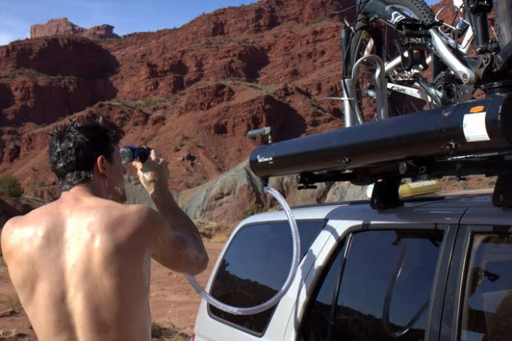 The Road Shower uses the Sun to heat its matte-black water tank