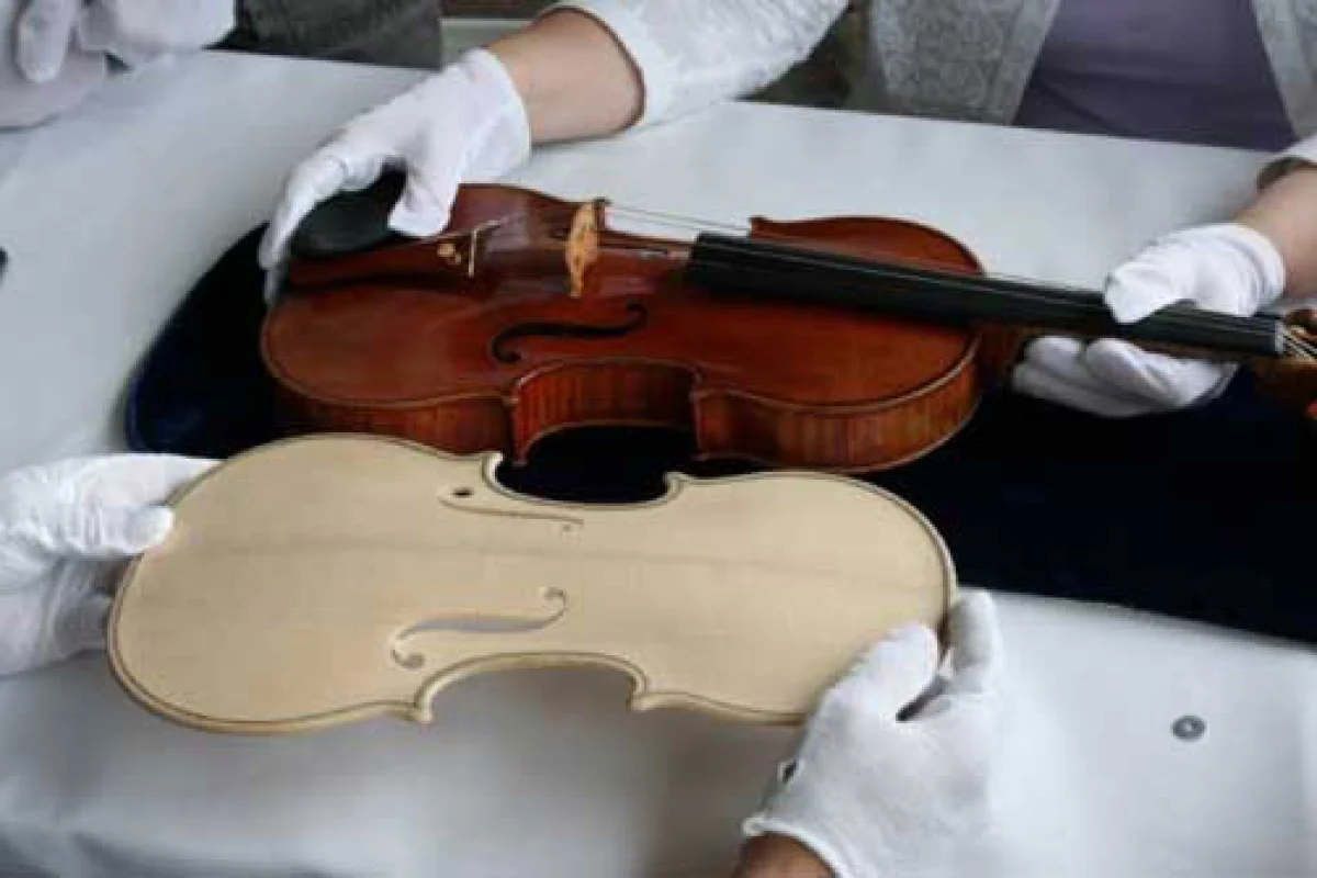 Photograph comparing the original Stradivari Betts violin with the carved plate of the reproduction. (Photo: RSNA)