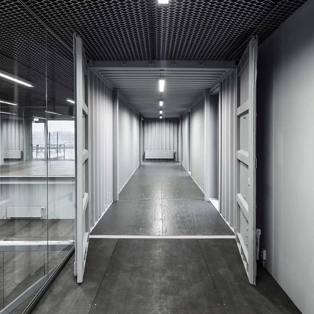 Made to be Moved features used shipping containers – complete with dents – that have been painted grey to produce a uniform look