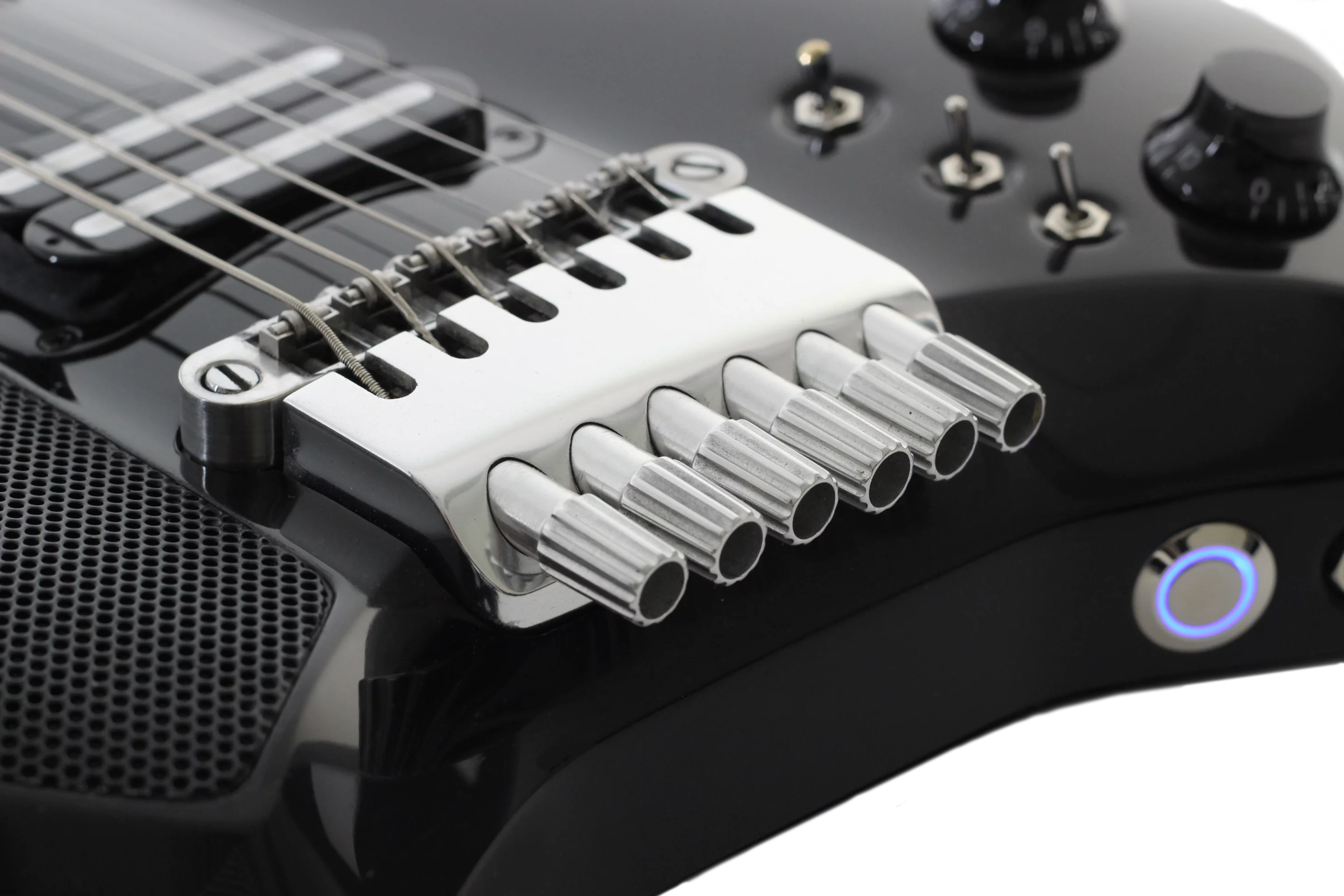 The string tuning system is down by the bridge