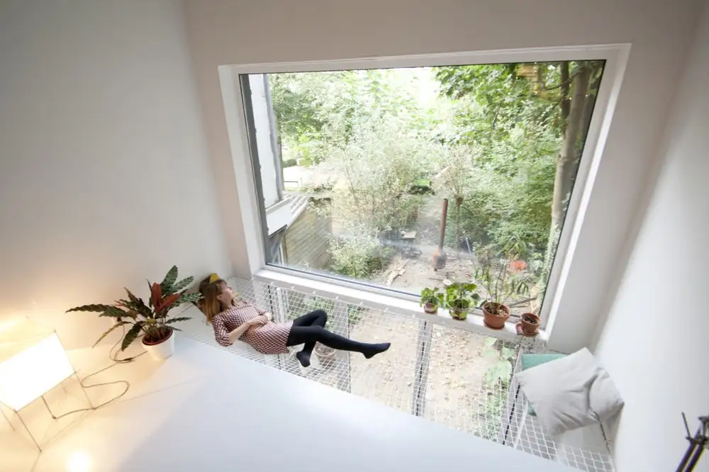 The SkinnyScar's second floor contains a small library facing the street and a lounge with a net hammock that overlooks the garden