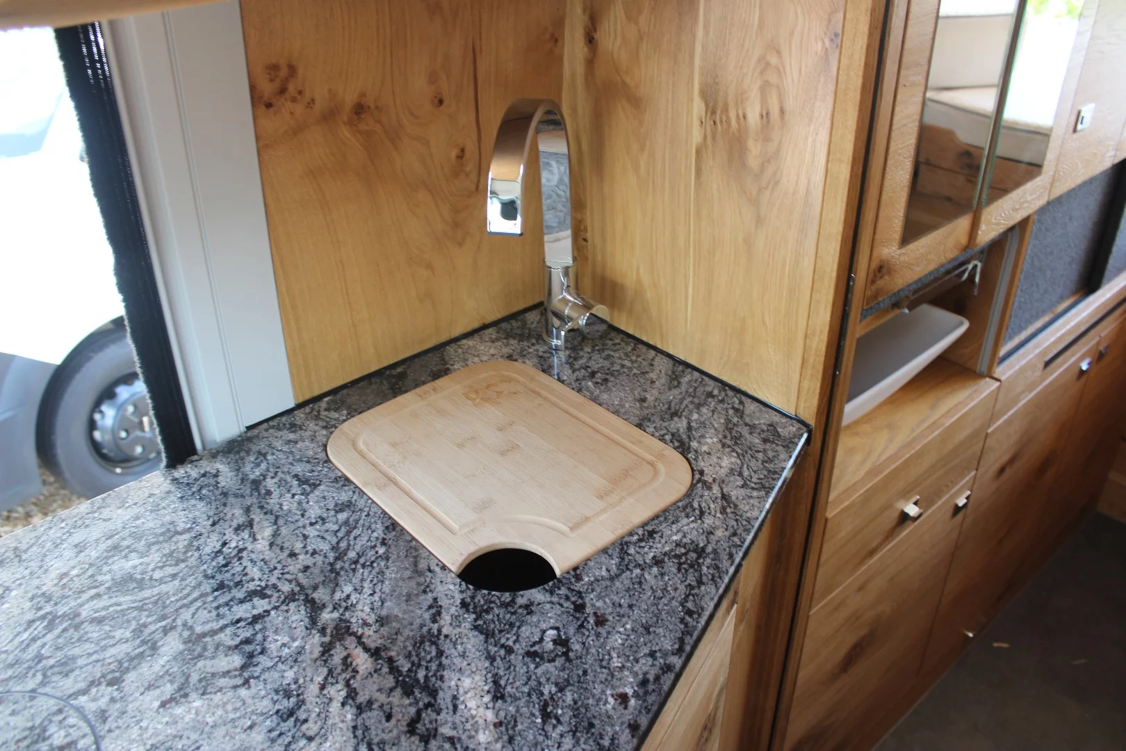 We reckon you could just use the kitchen sink, but Huenerkopf keeps things a little more hygienic and separate with its slide-out sink across from the bathroom