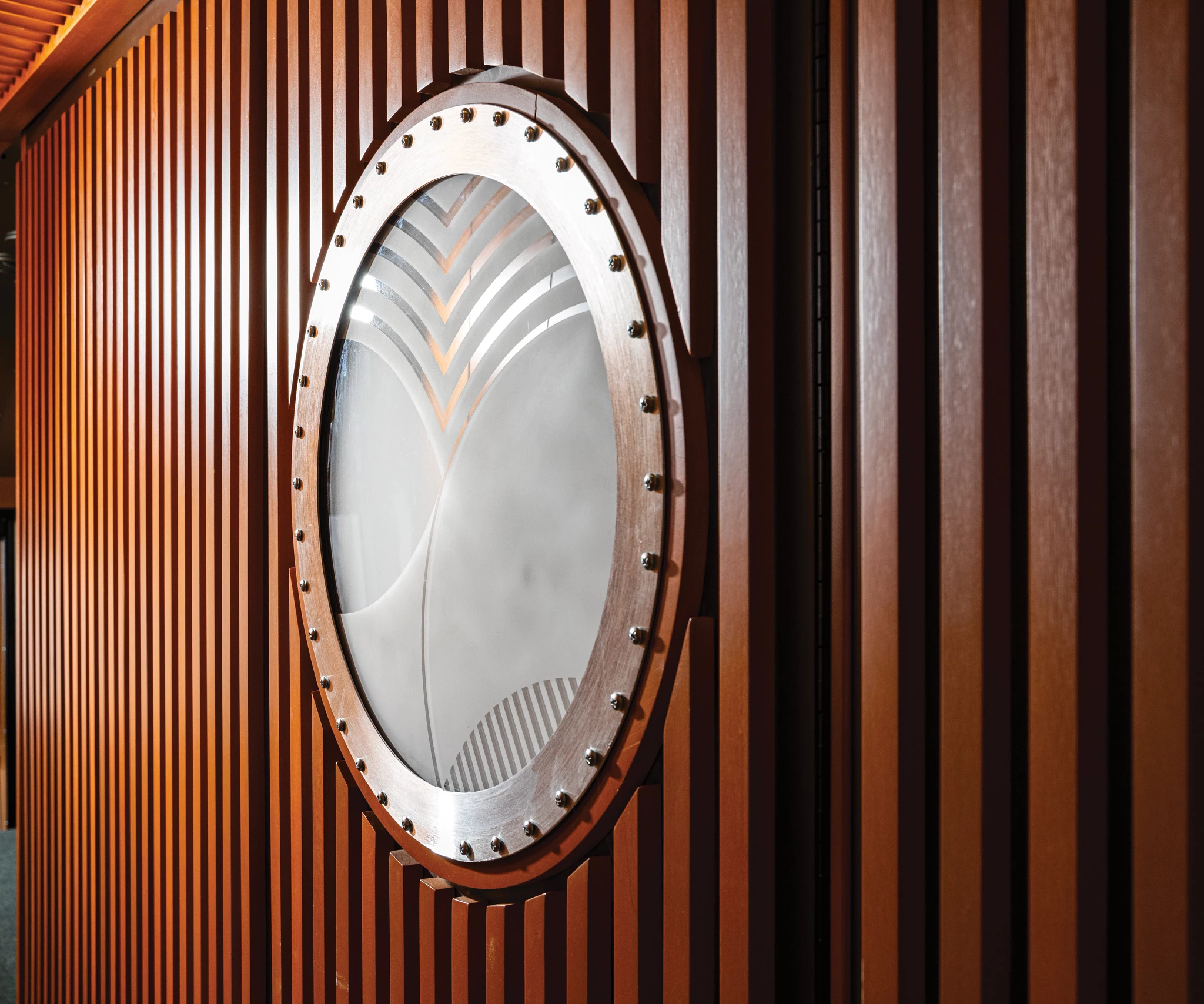 Porthole windows on the entry door and bathroom wall tie into Frank Lloyd Wright's affinity for circular design elements