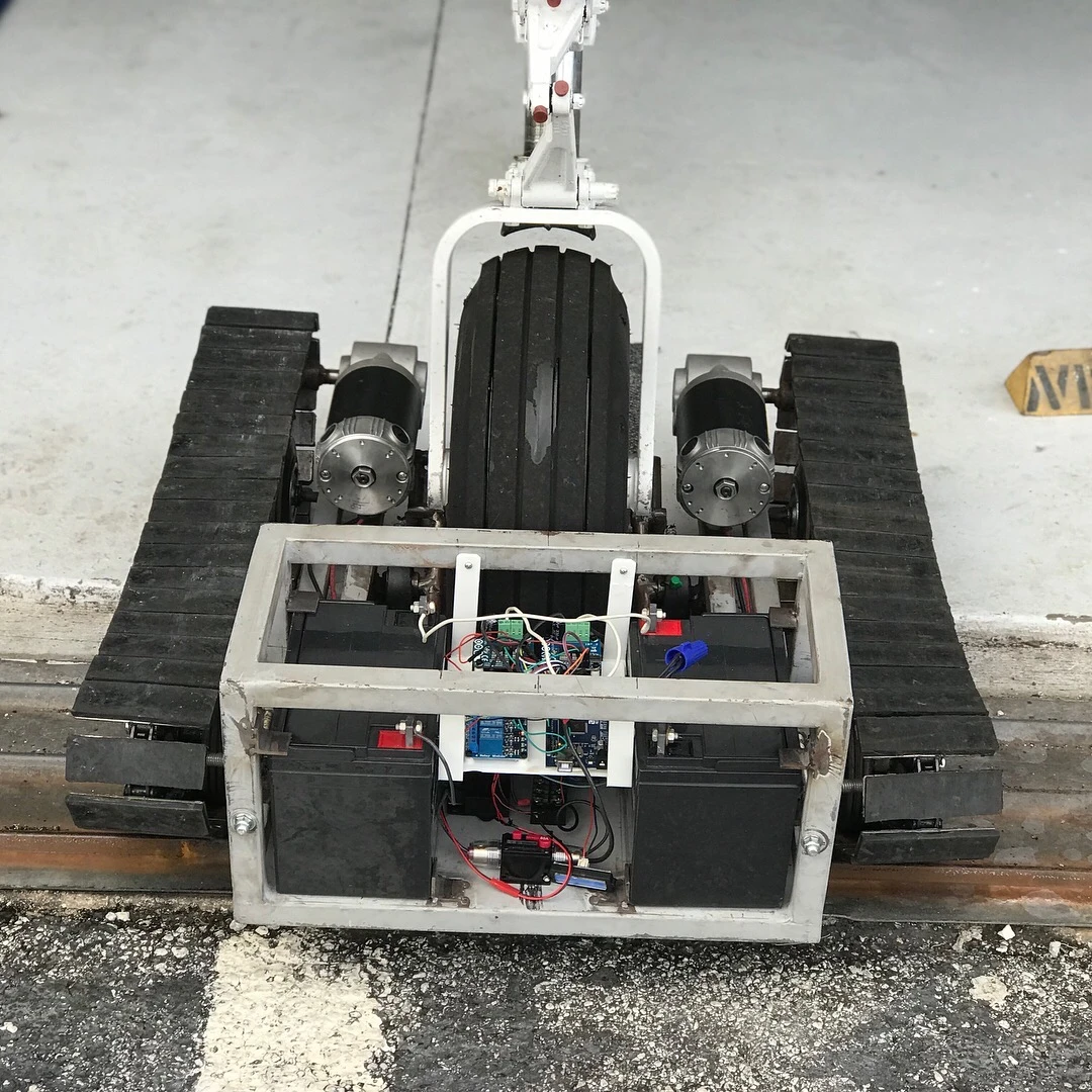 Two 12 V power chair batteries sit in the cage at the front of the Aircraft Tug, with electronics inbetween