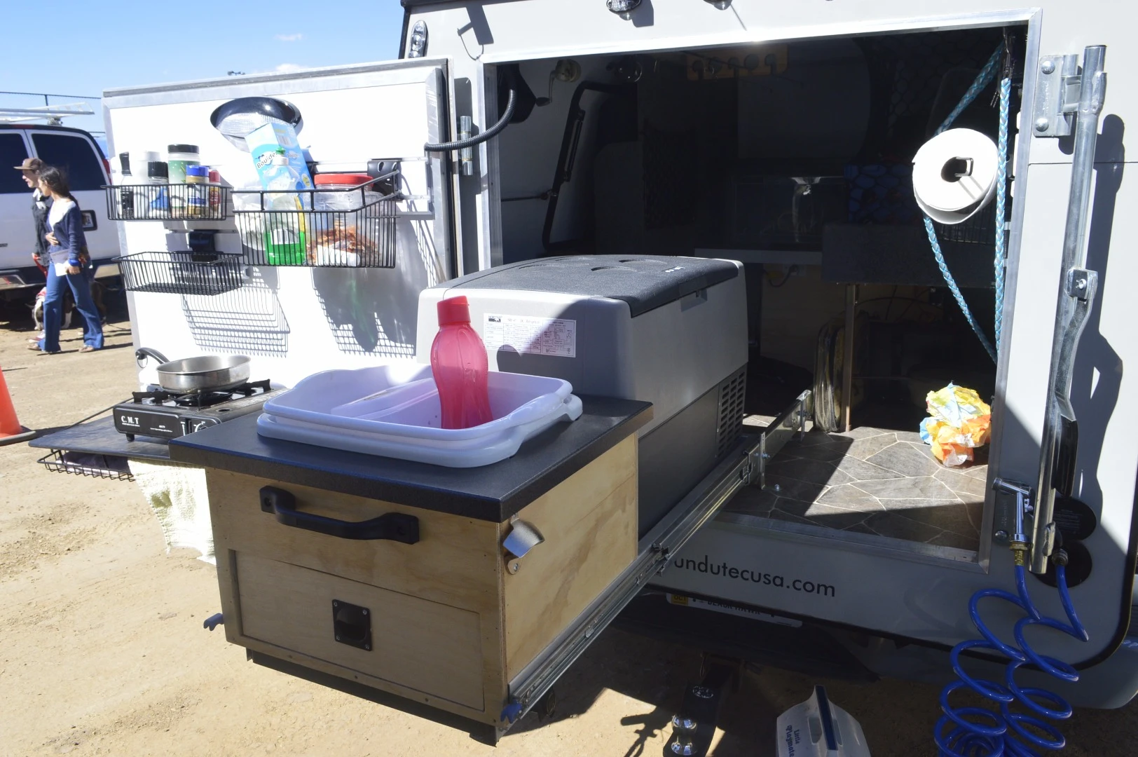The pull-out kitchen here includes a Dometic refrigerator and wash basin