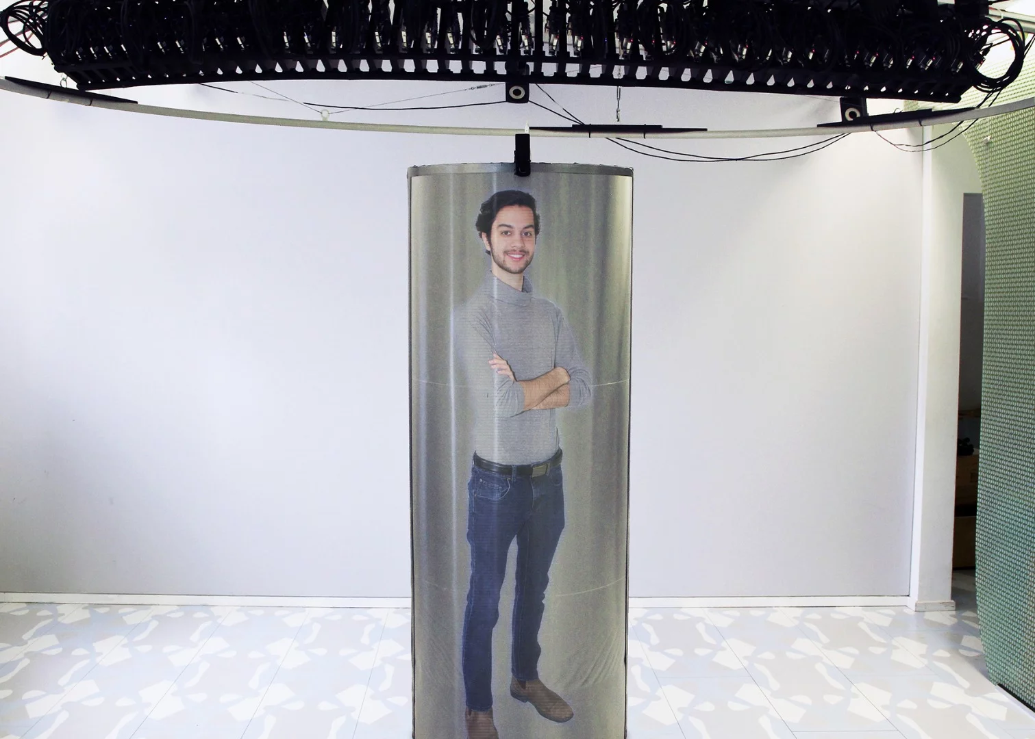 The TeleHuman 2 system uses an array of intelligent projectors to produce a 3D hologram