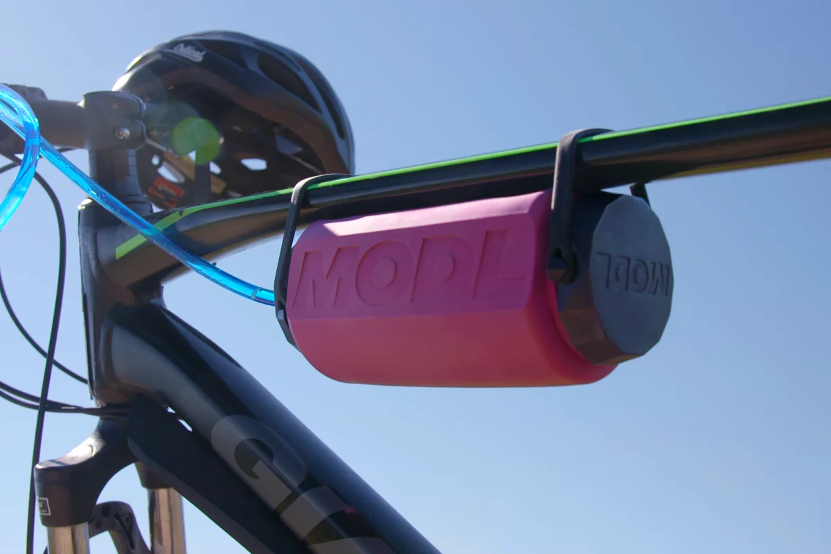 The MODL with its Flow Mod installed, mounted on a bike frame using its integrated silicone straps