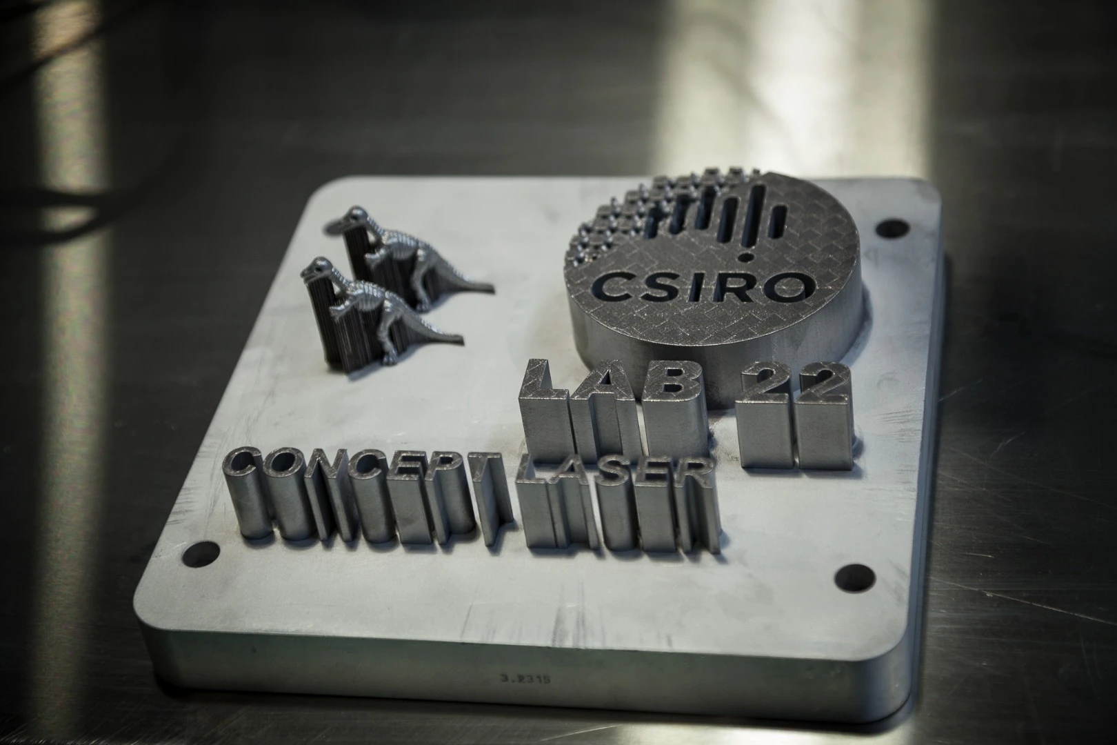 Demo print from the Concept Laser machine, showing the cross-hatched pattern typical of laser-melted titanium
