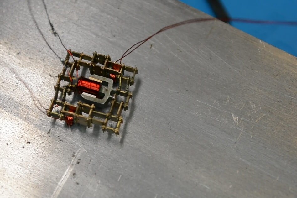 This walking microrobot was built by the MIT team from a set of just five basic parts, including a coil, a magnet, and stiff and flexible structural pieces