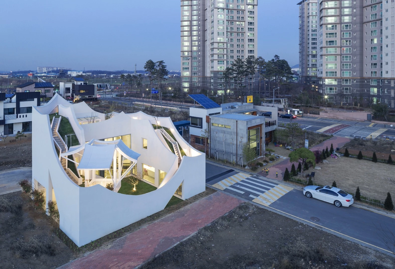 According to Iroje KHM Architects, the unfinished concrete was used to keep costs down