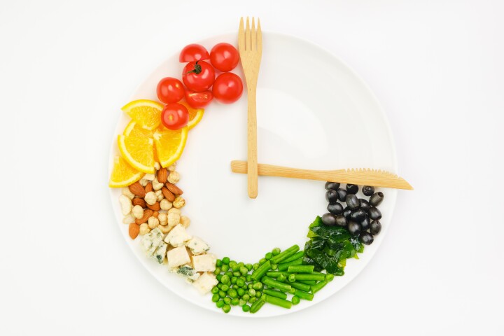 Research findings indicate smaller meals and eating less frequently are more important to losing weight than the time of day one eats