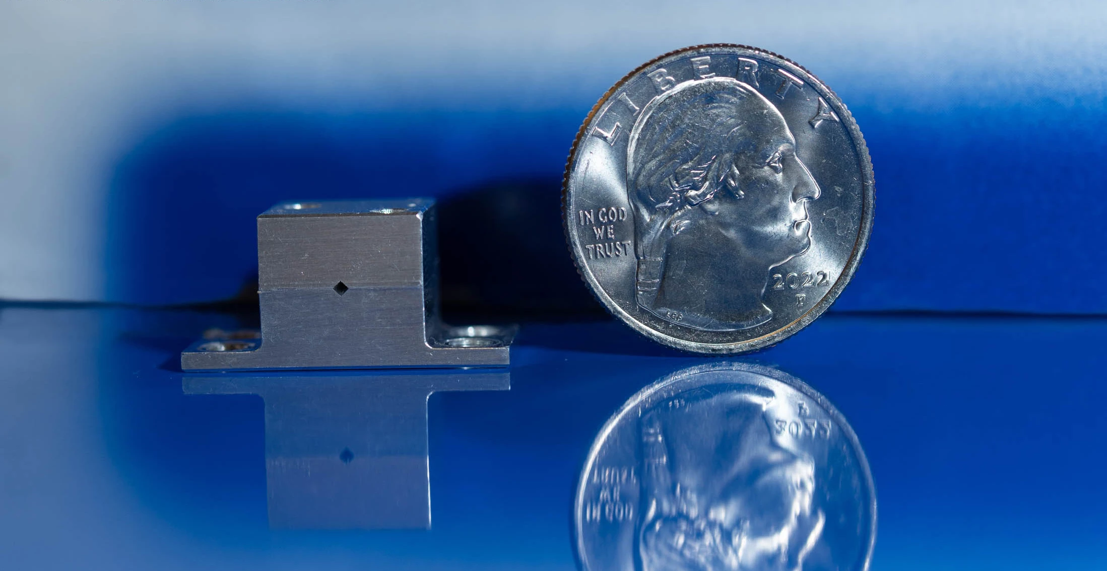 The new quantum cascade laser, which could help astronauts hunt for water on the Moon, next to a US quarter for scale