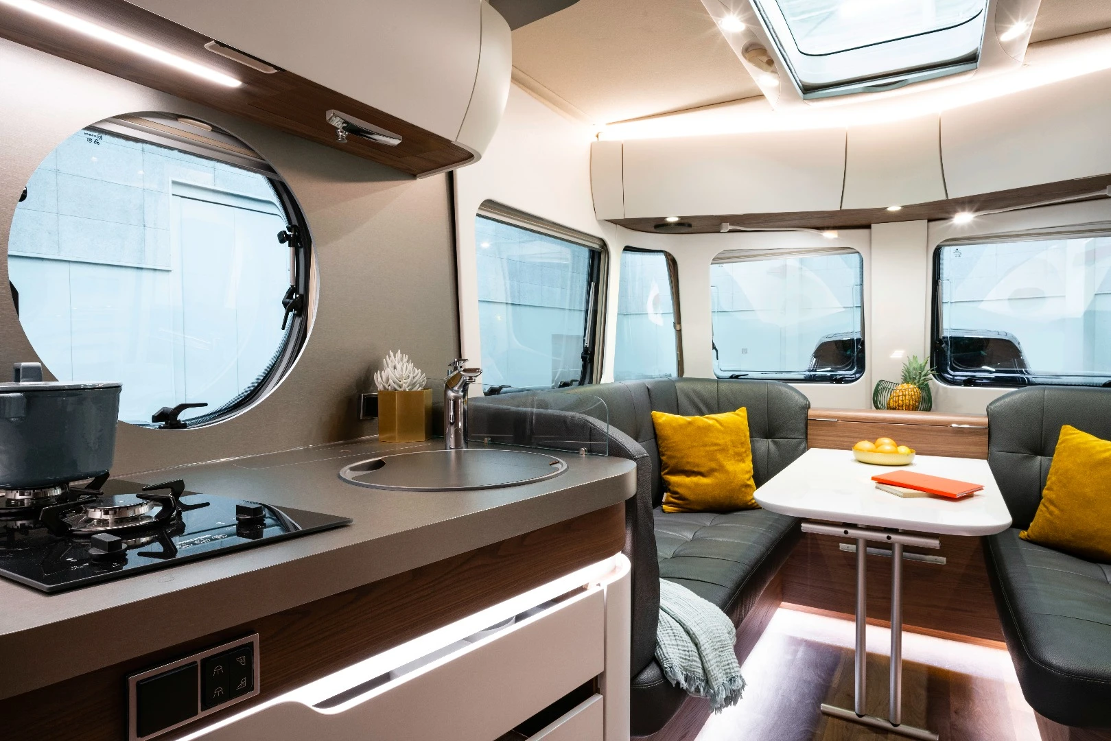 The kitchen area includes a dual-burner stove and sink