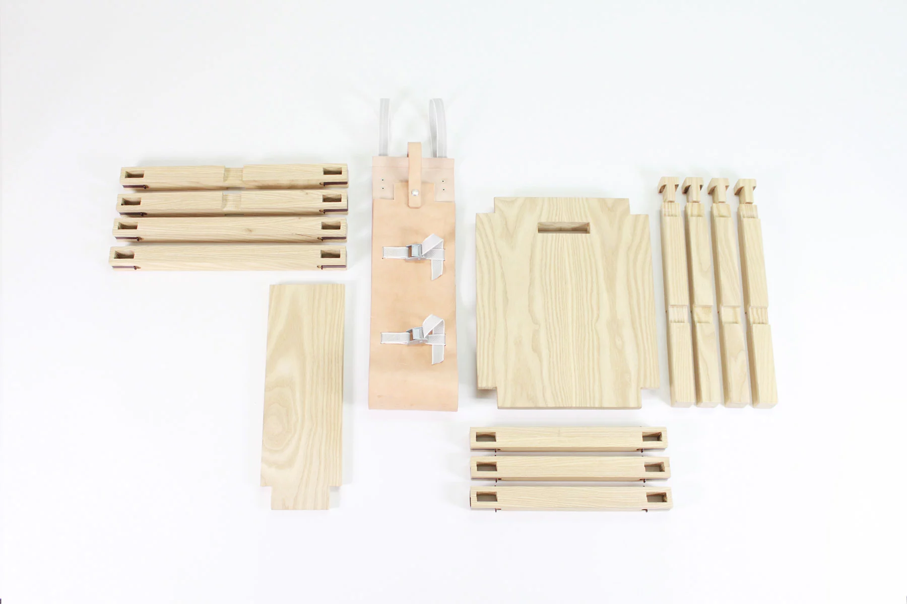 Nomadic Chair in its disassembled state, with steel clips required to turn it into a piece of furniture