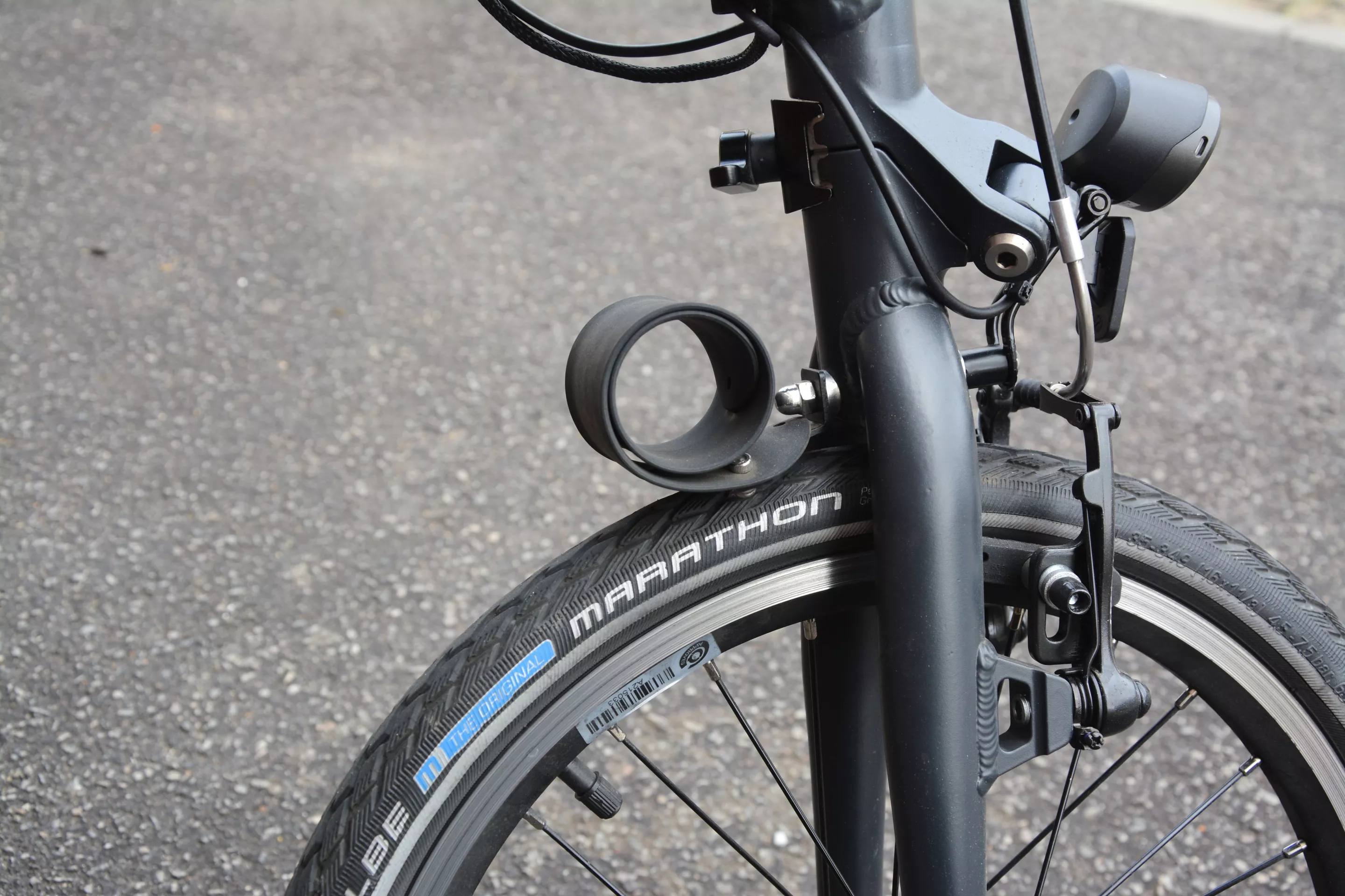The dinky front and rear fenders coil back towards the frame between rides so that the ebike can be rolled along on its wheels when folded