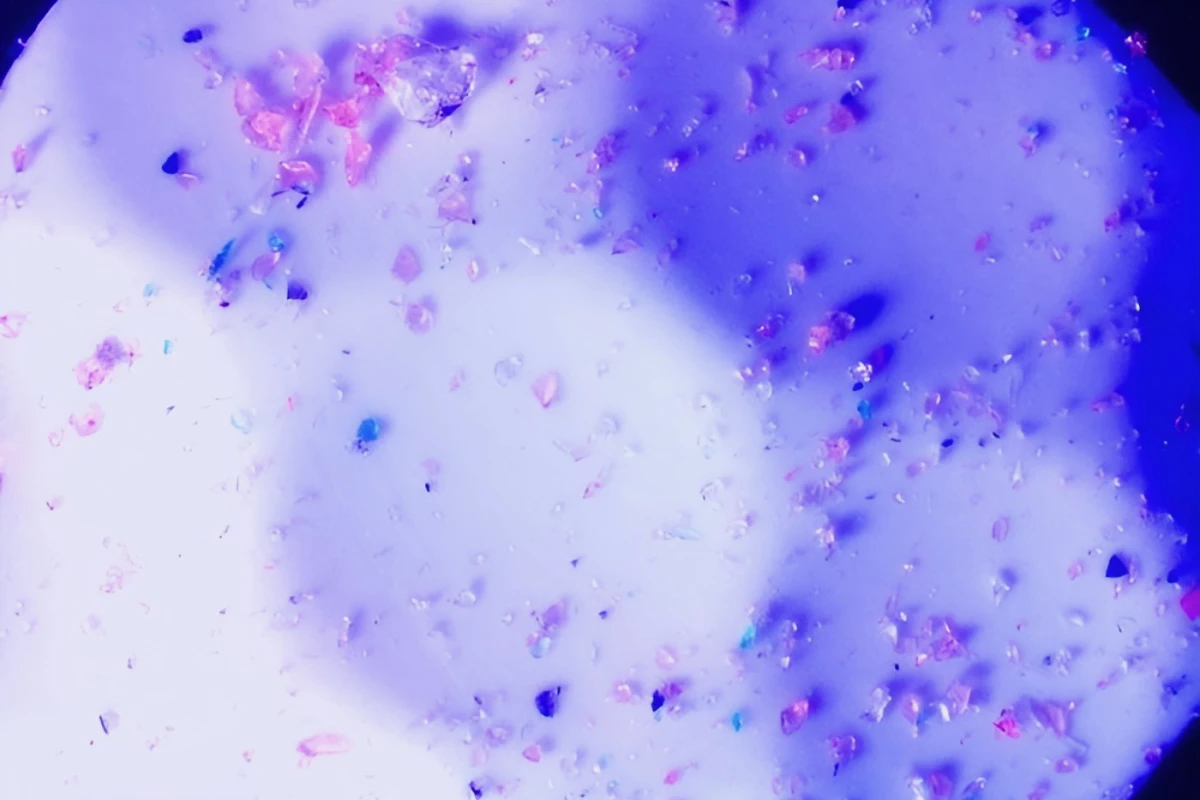 The coating contains tiny crystals of absorbent silica, which are visible in this microscope image of the material on a standard golf ball