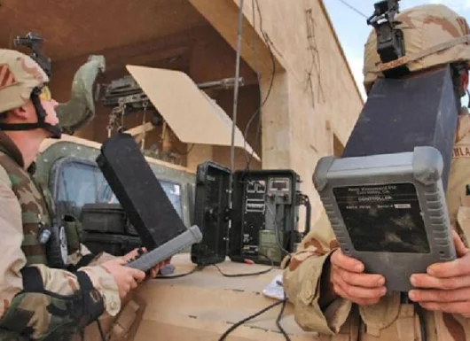 Cpl. Christopher Chladny (right) and Staff Sgt. Joshua Rygiel fly the Raven using their navigation computer near Tikrit, Iraq. The aircraft has cameras mounted on it for surveillance of possible enemy activity.