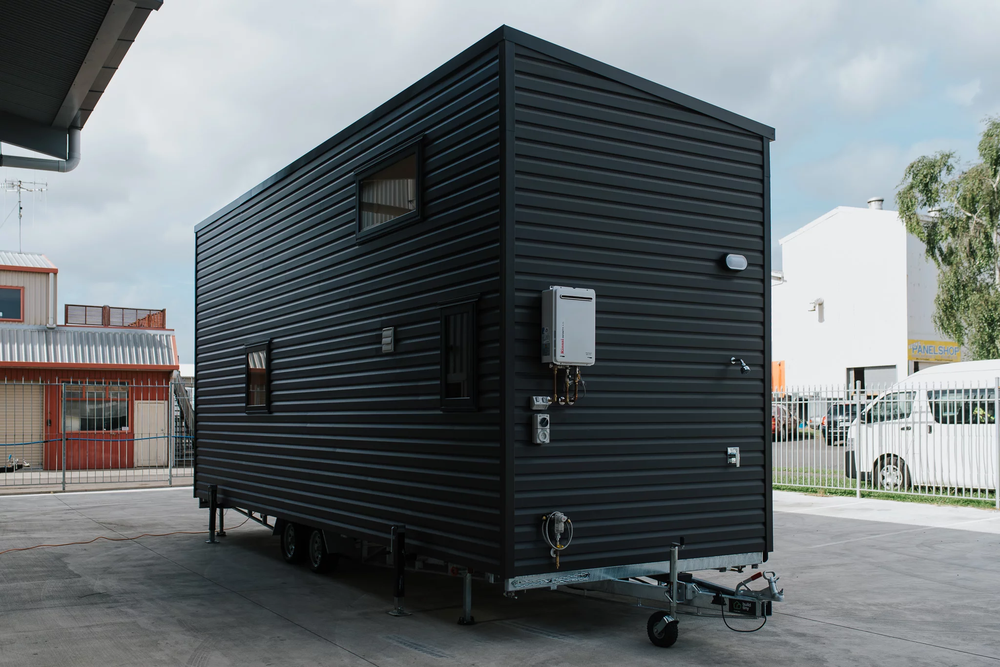 The Home Haven is finished in black vinyl and has an outdoor shower attached to the exterior