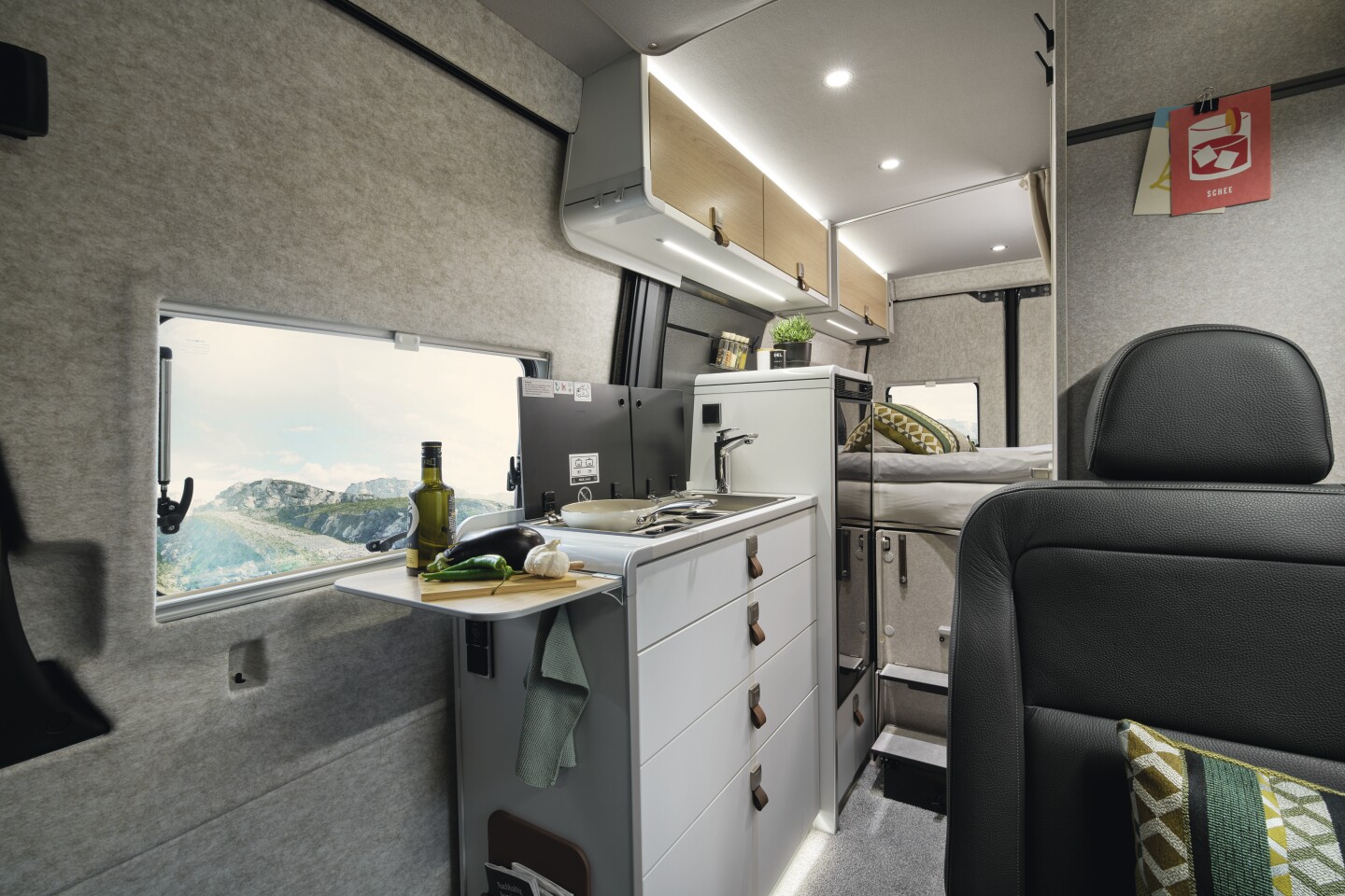 The Xperience kitchen features a combo sink/dual-burner stove, flip-up counter extension and large 90-L fridge/freezer