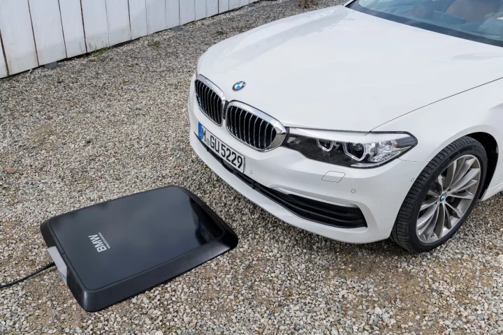 A base pad is placed on the parking space and plugged into the power source – when the vehicle is parked over the top of the pad, inductive charging begins