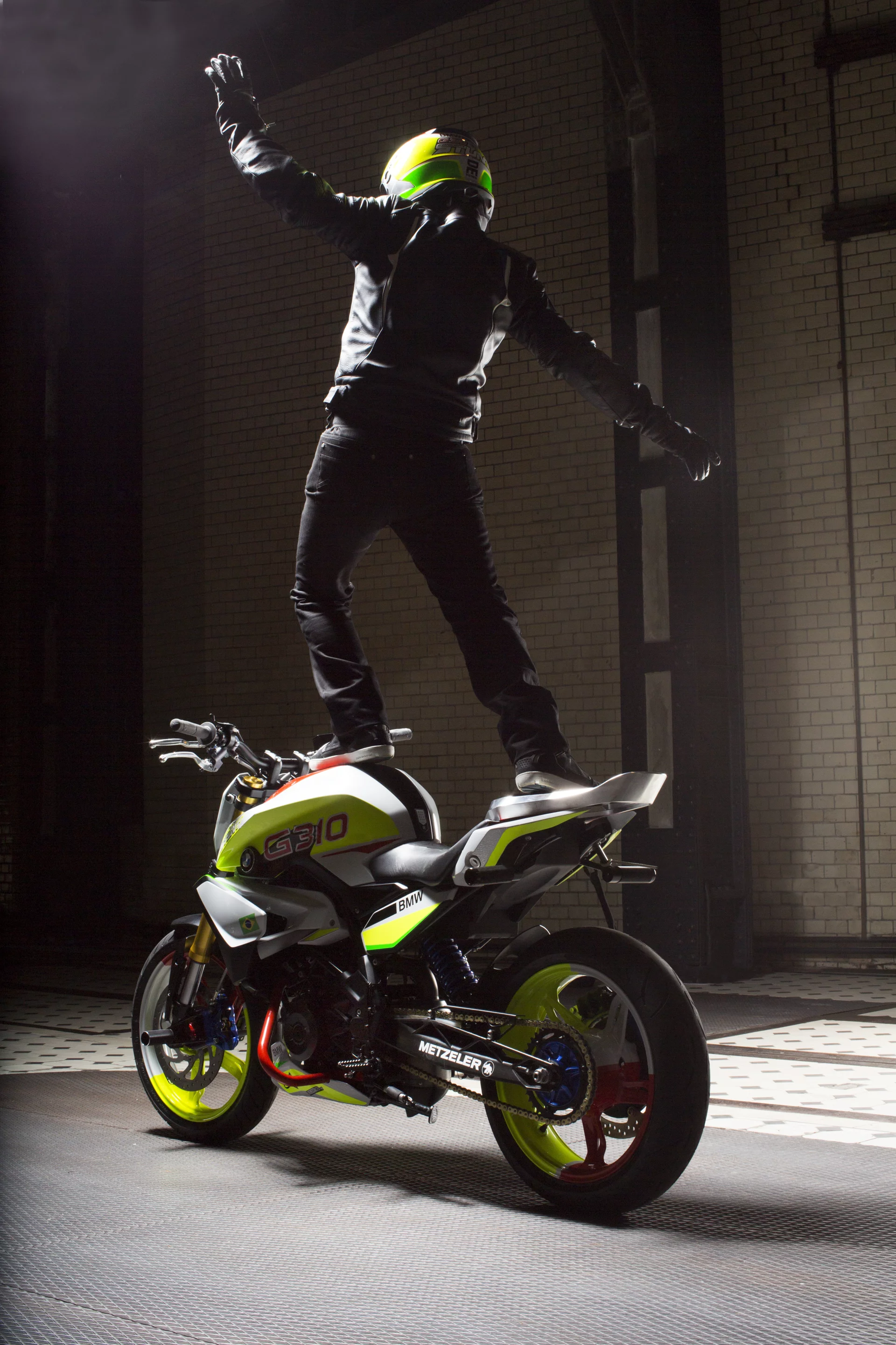 Christian Pfeiffer rides the BMW Concept Stunt G 310, standing on the tank