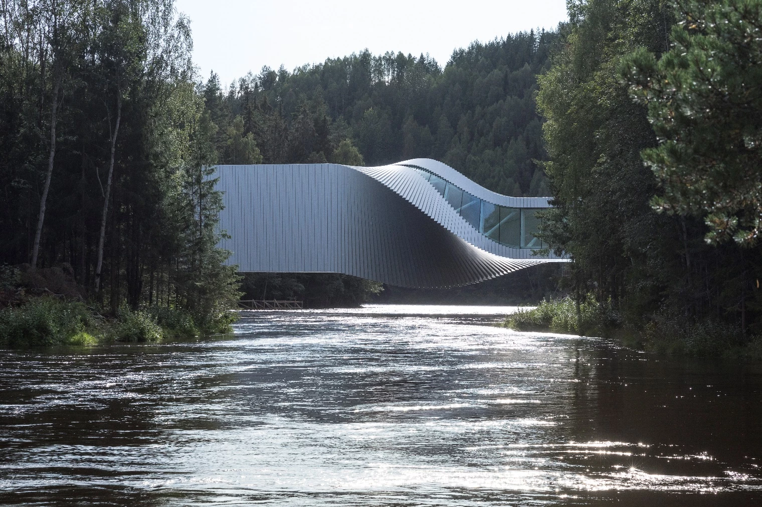 "The Twist constitutes a tectonic enigma," says BIG's Bjarke Ingels. "As the bridge connects the two riverbanks – a mountain slope and flat forest – it rotates 90 degrees forming a warped, ruled surface"