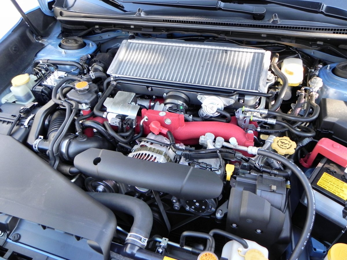 The engine compartment of the powerful STI model is mostly about airflow management