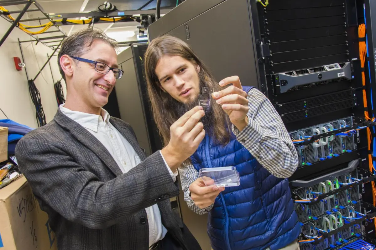 Worcester's Prof. Erkan Tüzel (left) and PhD candidate James Kingsley examine the SPARTAN device