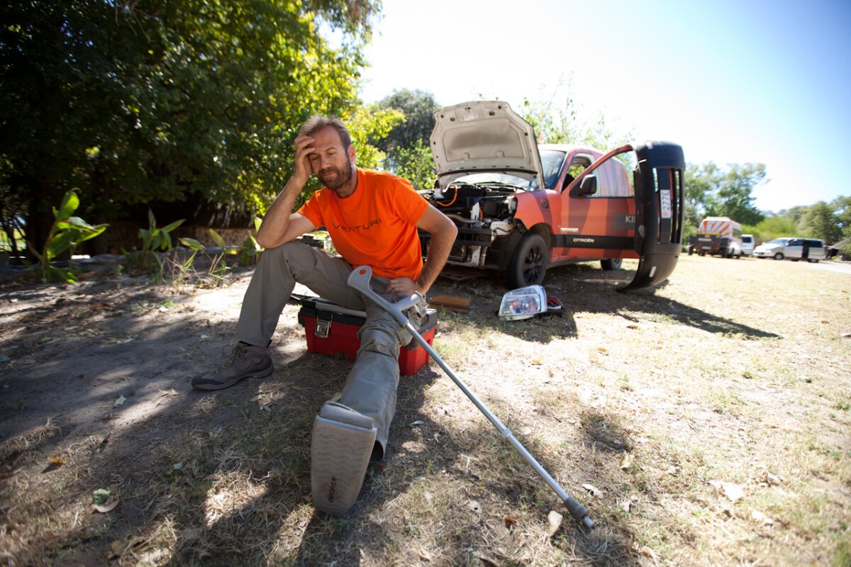 While trying to disconnect cabling across a shed roof in Kabwe, Zambia he fell through, breaking his foot, but continued his journey anyway