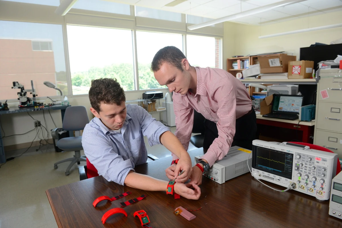 Researchers work with prototype HET wristbands